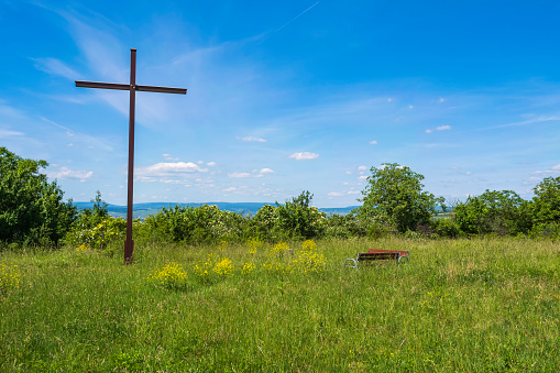 View towards the cross at Wißberg/Germany under a white-blue sky
