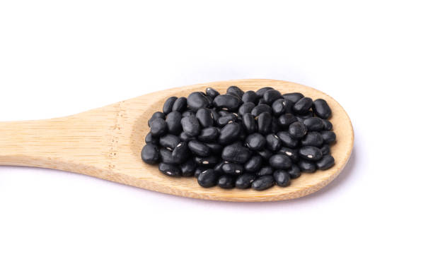 istock Black beans on a spoon isolated over white background 1408041035