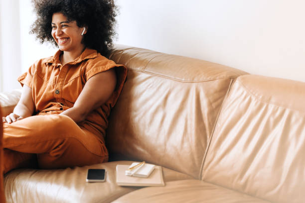 istock Cheerful female entrepreneur taking a phone call using wireless earphones 1408042236
