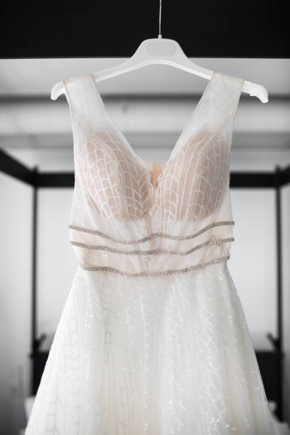 istock Wedding dress hanging over the bed 1408042272