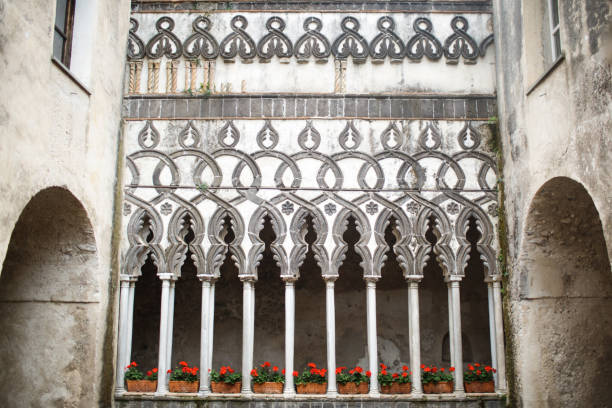 istock Indoor plants in flower pots stand between stone columns 1408042328
