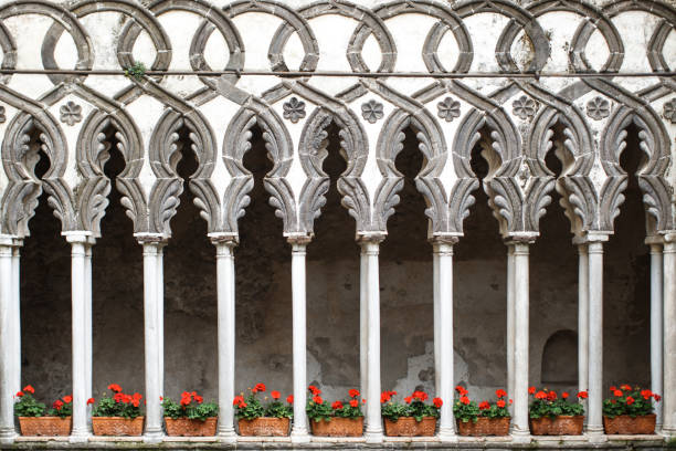 istock Indoor plants in flower pots stand between stone columns 1408042337