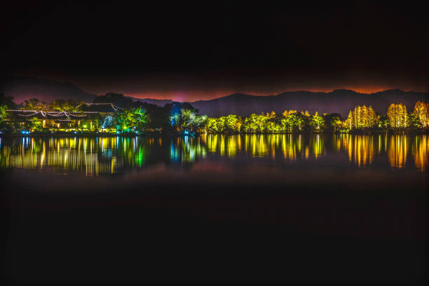 Illuminated West Lake Hangzhou Night Lights Wide Reflection Zhejiang China .