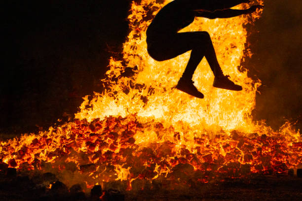 istock Summer solstice celebration jumping into the fire. Burning flames 1408046080
