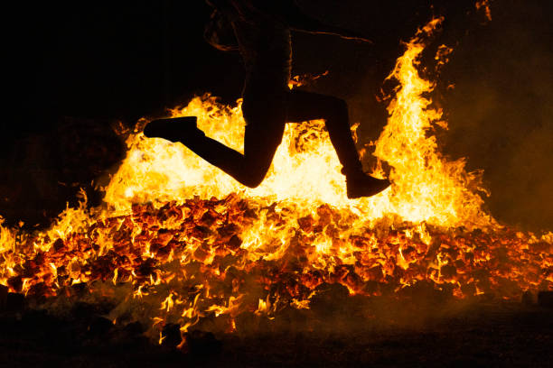 istock Summer solstice celebration jumping into the fire. Burning flames 1408046642