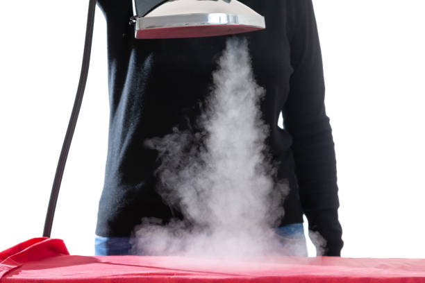 istock Vertical jet of steam from an iron on black background 1408047255