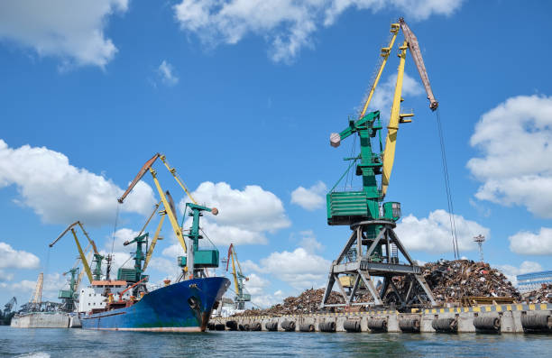 Cargo ship in port under cranes in Kherson, Ukraine.