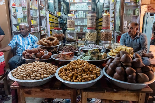 Hyderabad, India - September 2018: Shopkeepers at an old shop selling exotic spices in the market in Charminar in old Hyderabad.