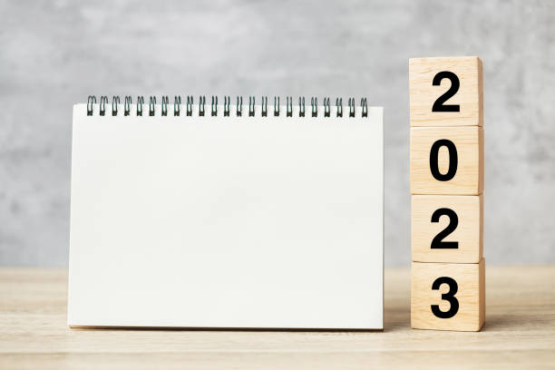 istock 2023 Happy New Year with blank notebook and wooden number. countdown, Resolution, Goals, Plan, Action and Mission Concept 1408049936
