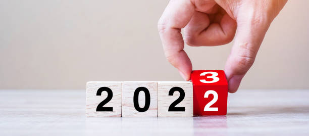 ręczny blok przerzucania tekstu 2022 do 2023 na stole. rozwiązanie, strategia, plan, cel, motywacja, restart, biznes i koncepcje świąt noworocznych - aiming challenge business throwing zdjęcia i obrazy z banku zdjęć