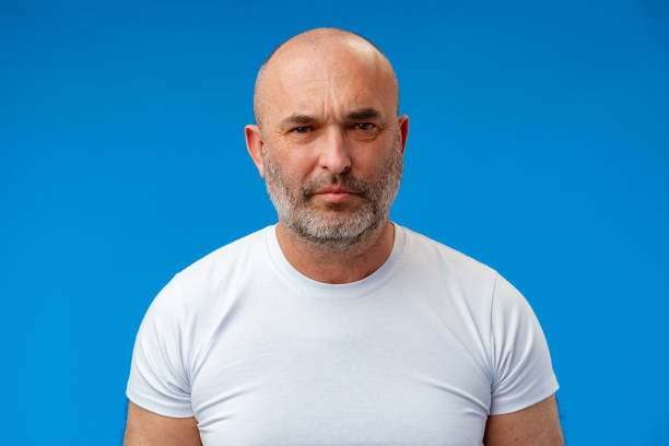 istock Portrait of a middle-aged man against blue background in studio 1408050517