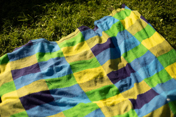 istock Green plaid on beach. Bedspread at picnic. Tablecloth for eating. Blanket for relaxation. 1408054667