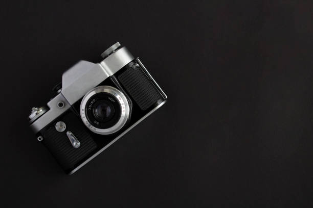 istock Old photocamera on the black background. Top view. Copy sace. 1408055340