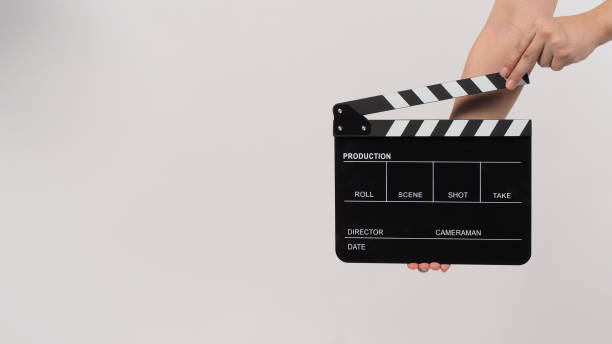 istock Hand is holding Black clapperboard or movie slate on white background. 1408055360