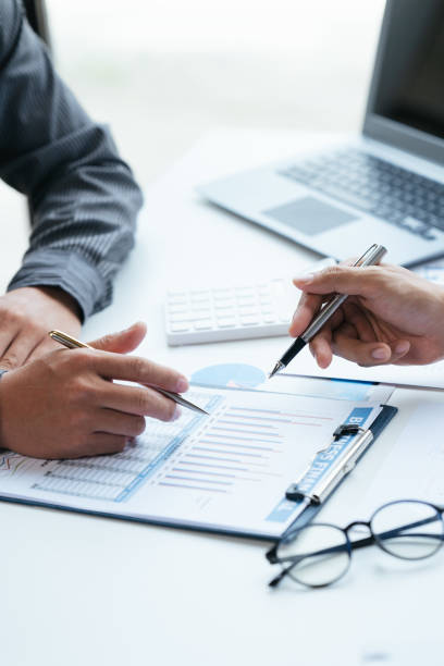istock Group of business people meeting, discussing, analyzing graphs, financial data, and planning a marketing project together 1408055949