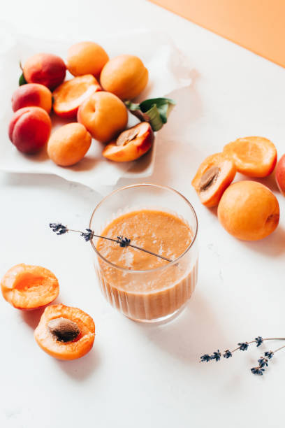 istock close-up on ripe apricots and apricot smoothie on white background 1408056085