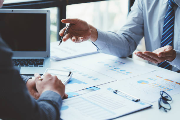 istock Group of business people meeting, discussing, analyzing graphs, financial data, and planning a marketing project together 1408056110