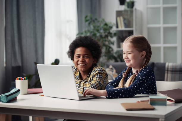 istock Children using laptop at table at home 1408056371