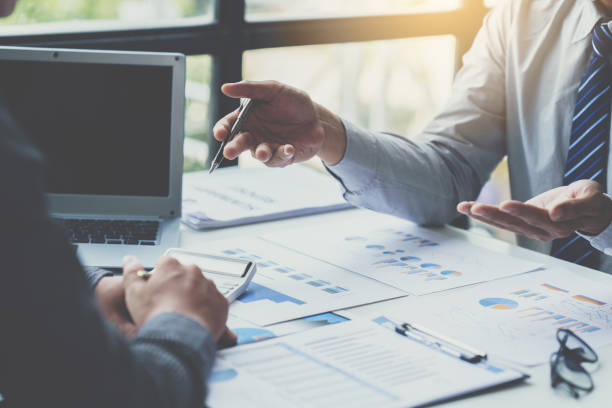 istock Group of business people meeting, discussing, analyzing graphs, financial data, and planning a marketing project together 1408056800