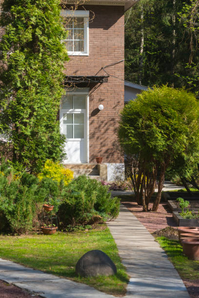 istock Private brick house with a beautiful garden in front of it 1408057573