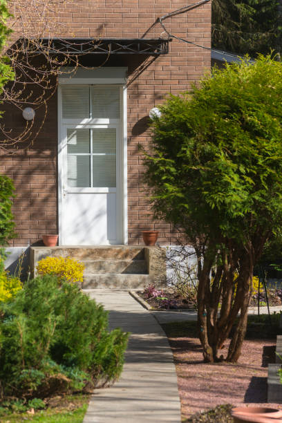 istock Private brick house with a beautiful garden in front of it 1408057785