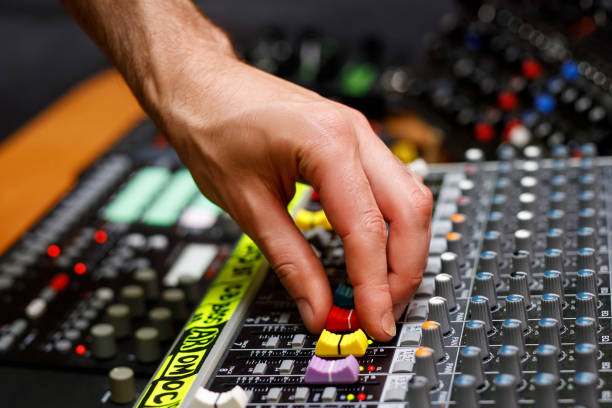 istock Hand of a sound engineer on sound console mixer. Equalizer control. 1408058713