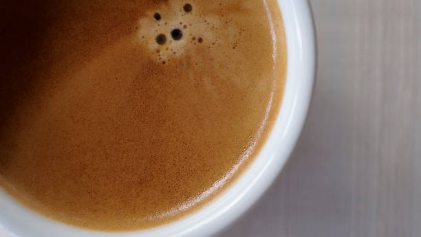 Close up Coffee froth on a hot coffee cup. Ready to drink hot cofffee Close up Coffee froth on a hot coffee cup. Ready to drink hot cofffee black coffee swirl stock pictures, royalty-free photos & images