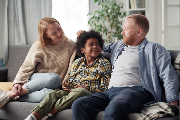 istock Family of three sitting at home 1408059556