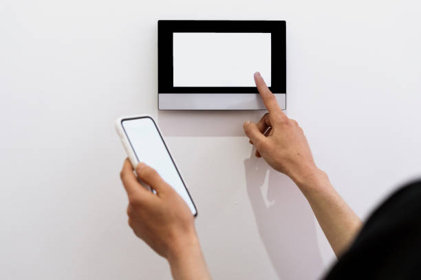 istock Woman controlling smart home devices, use her modern smartphone 1408059678
