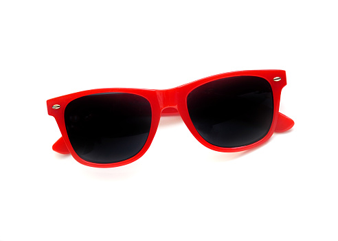 Closeup of red sunglasses on a white background.