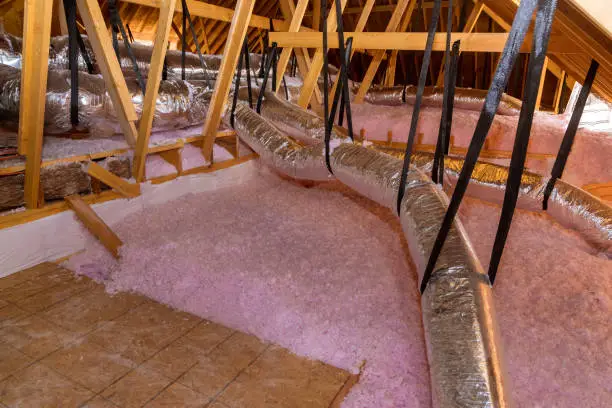 Photo of Eco wool insulation is poured in the attic insulation roof