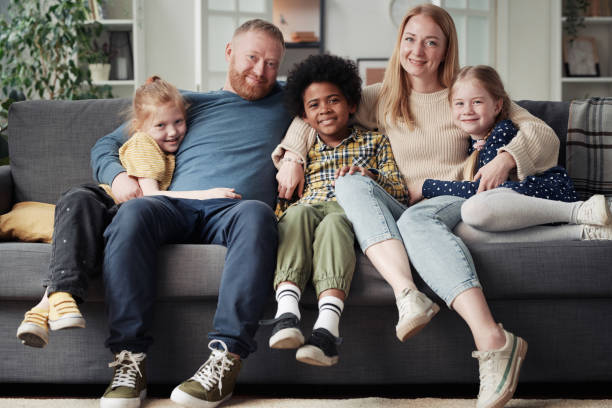 istock Big adoptive family sitting at home 1408062312