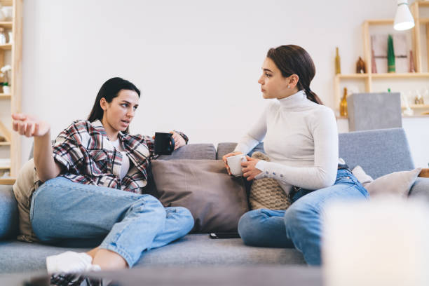 istock Cheerful female friends chatting with each other 1408062386