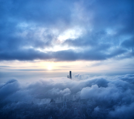Drone point view of Shanghai landmark building on thick cloud at morning, China.