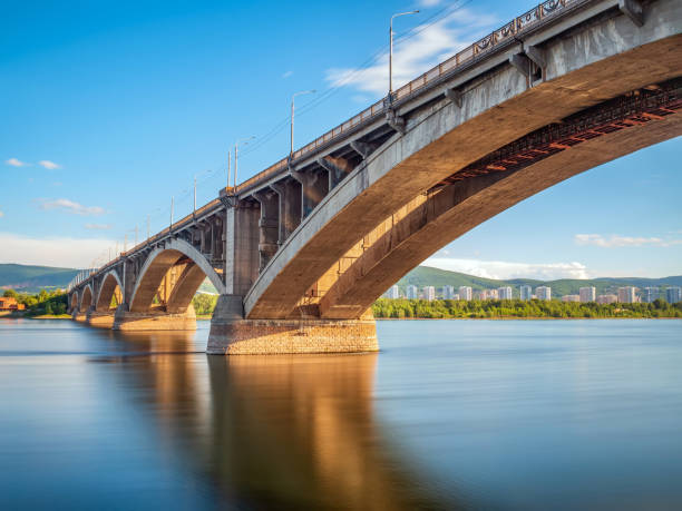 istock Reinforced concrete bridge over a wide river. Cityscape. 1408063401