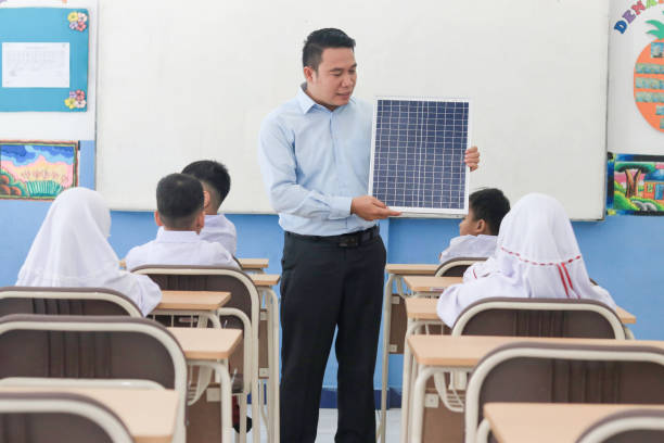 istock Schoolchildren with teacher studying solar panels in class 1408063838