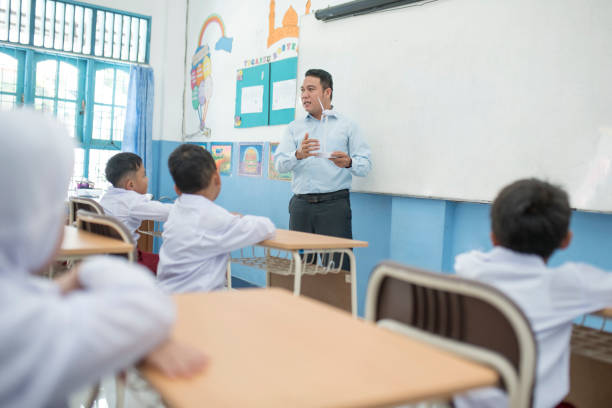 istock Teacher teaching concepts of windmill in the classroom to students 1408063893