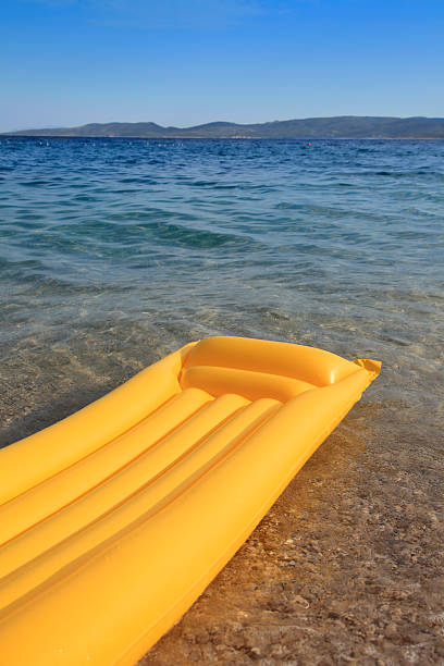 Yellow air mattress on the beach