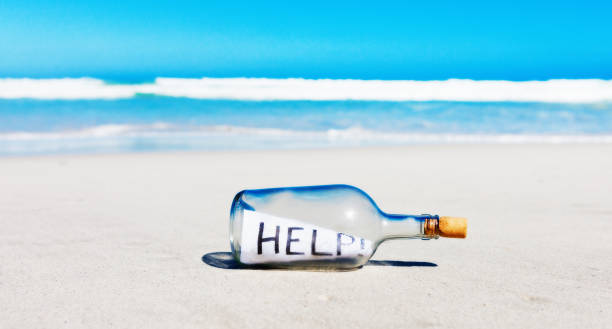 istock Castaway's message in a bottle on a beautiful coastline contains note pleading for help 1408066919