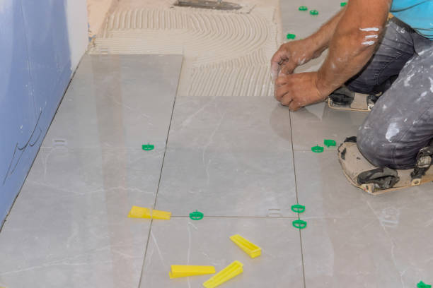istock Working on the tile leveling system in the bathroom with plastic clips and wedges 1408068053