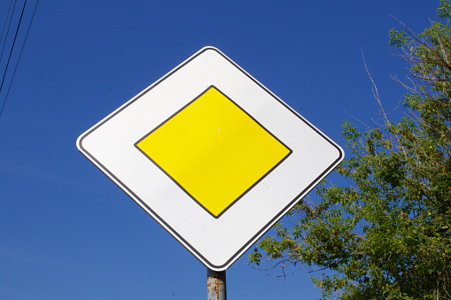 According to the traffic signs manual, this road sign's proper name is Right Reversed Curve. The photo is shot with a panoramic camera (Hasselblad XPAN), 45mm lens.