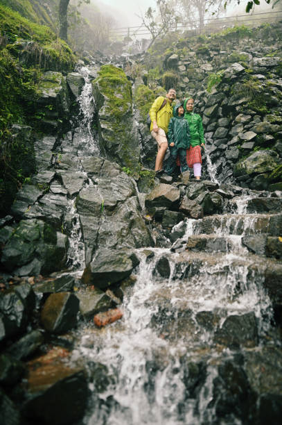 istock Family enjoying trek standing on steps with flowing water during monsoon 1408069352