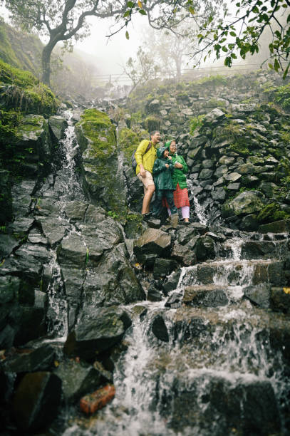 istock Family enjoying trek standing on steps with flowing water during monsoon 1408069356