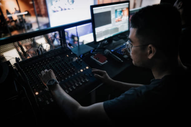istock asian sports event crew working at backstage with control panel on stage lighting , sound system and lighting effect 1408070780