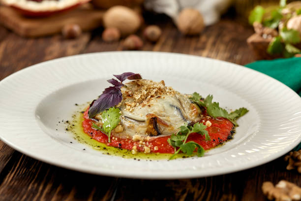 istock Hot appetizer - baked eggplant with cheese and tomatoes. Stuffed eggplants with mozzarella cheese and tomato sauce in rustic style. Eggplant and cheese appetizer on white plate in italian style. 1408071510