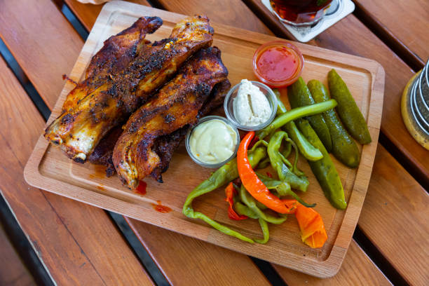 istock Grilled pork ribs with sauces, pickled vegetables 1408072564