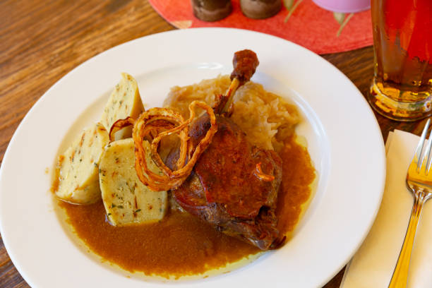 istock Confit duck leg with sauerkraut and dumplings 1408072571