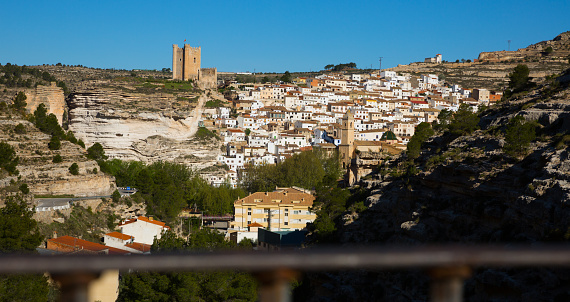 Panoramic view of Alcala del Jucar with mountains, buildings and castle