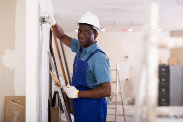 istock African american contractor plasters the wall indoors 1408073027