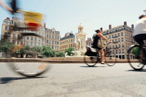 Bikers passing through Place des Jacobins, Lyon, France